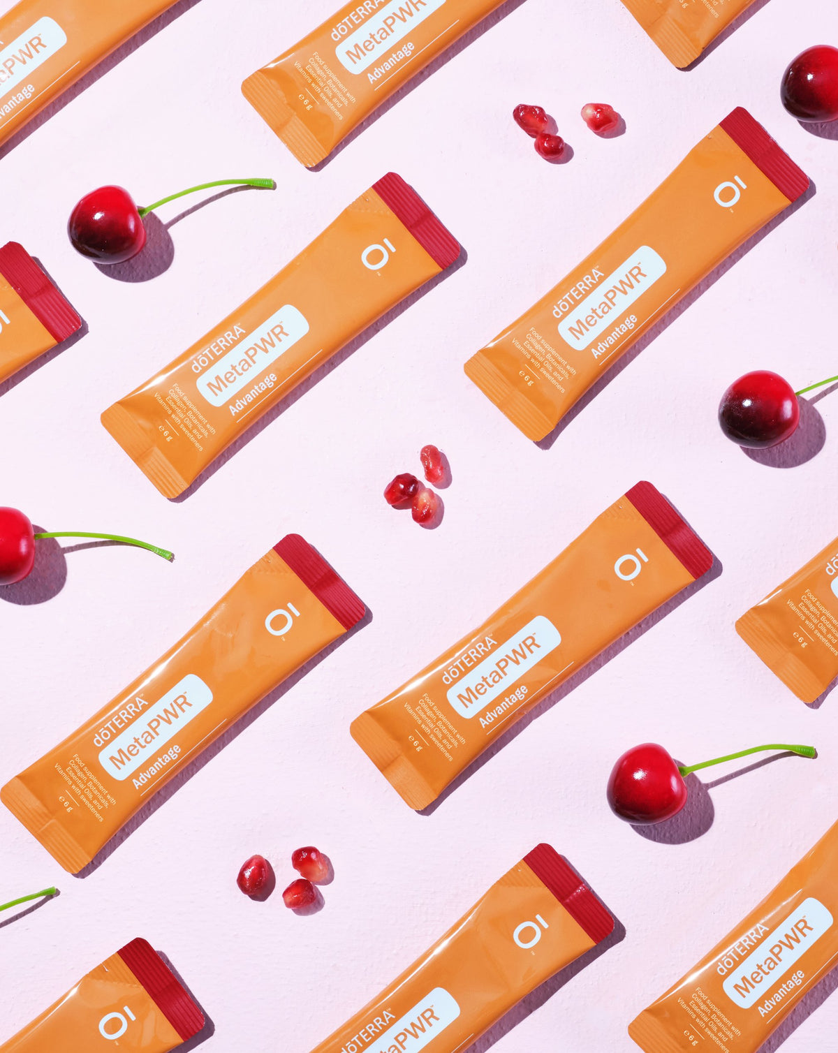 MetaPWR Advantage grenade-cerise dōTERRA, sachets et cerises sur fond rose