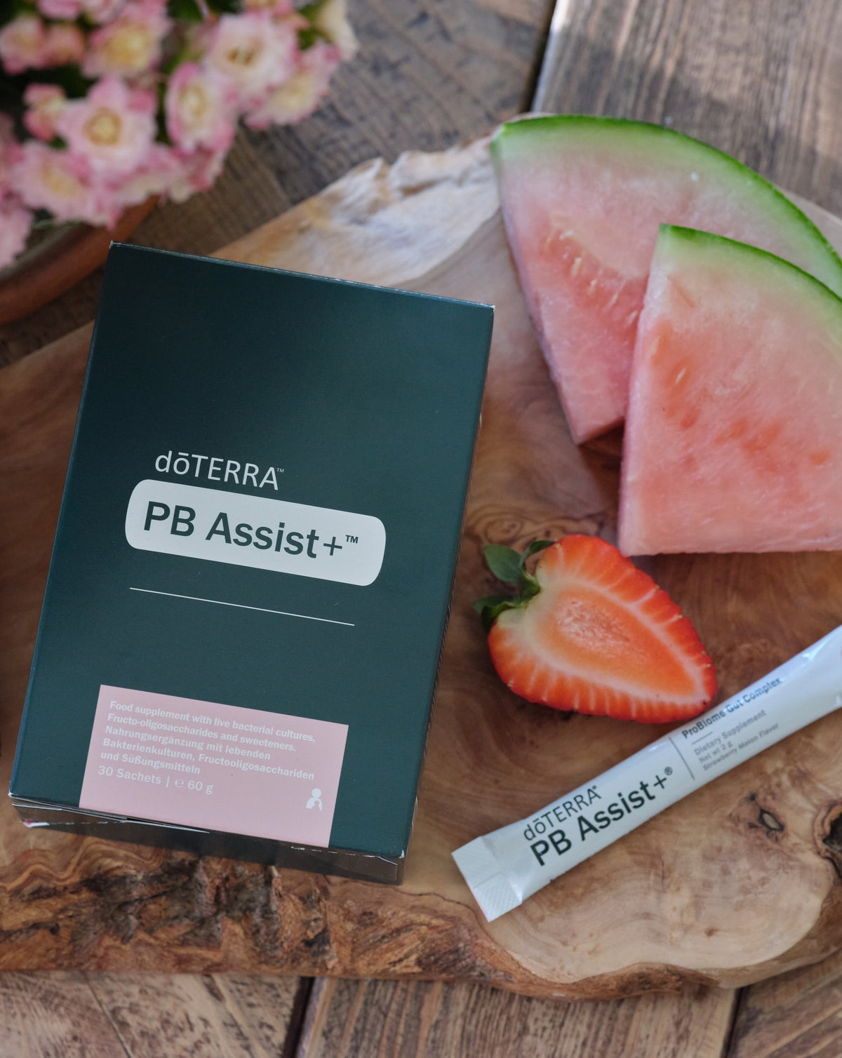 PB Assist+ dōTERRA, boîte et sachet avec fraises et pastèque